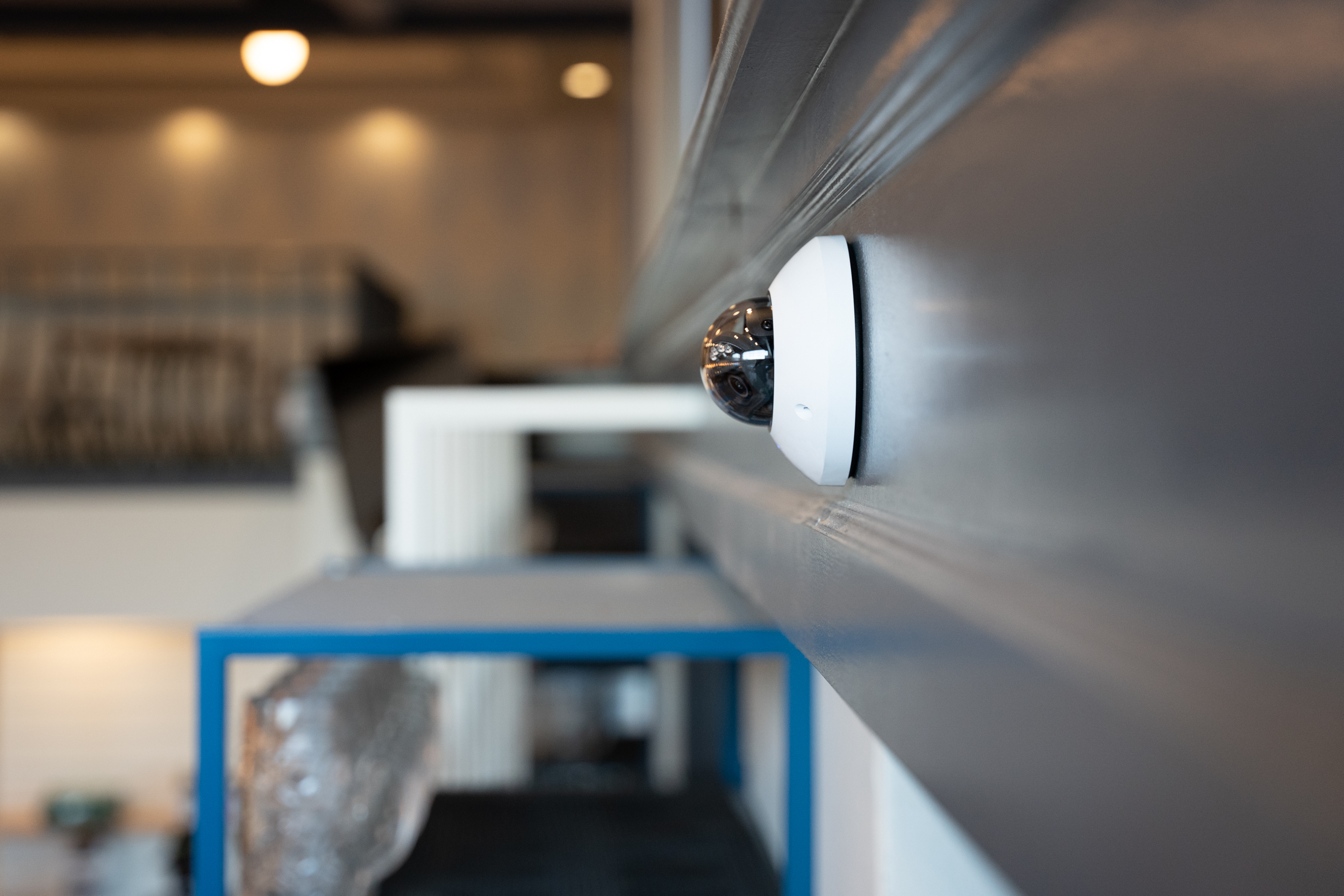 Security camera mounted on a wall inside a restaurant